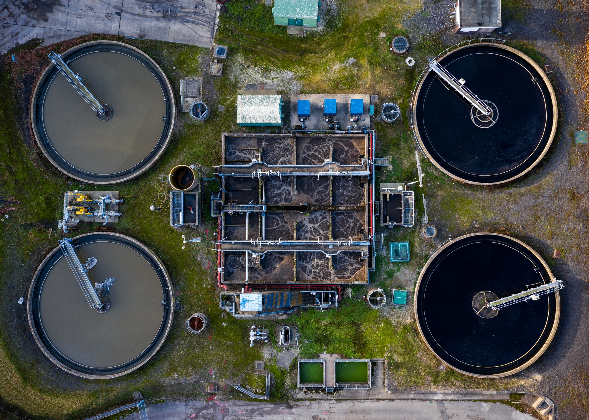 Aerial view directly above a waste water treatment plant with tanks purifying drinking water